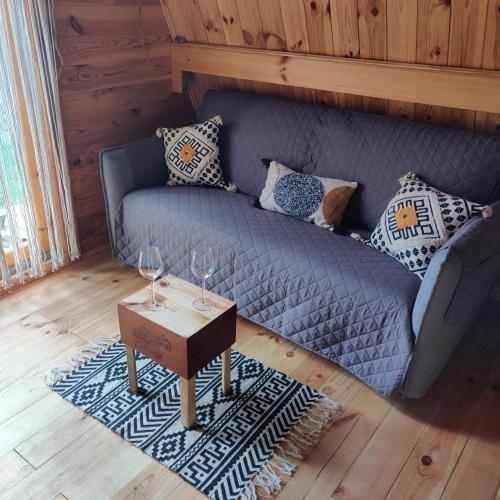 a living room with a couch and a table at Tipi Apache des monteaux in Vivy