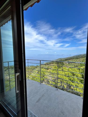a view from the door of a room with a balcony at Villa Pounta Family in Glóssa