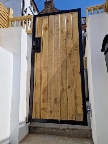 a wooden garage door with a black frame at Wesley Chapel- Cyanacottages in Whitby