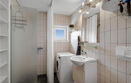 La salle de bains blanche est pourvue d'un lavabo et de toilettes. dans l'établissement Stunning Home In Harbore With House A Panoramic View, à Harboør
