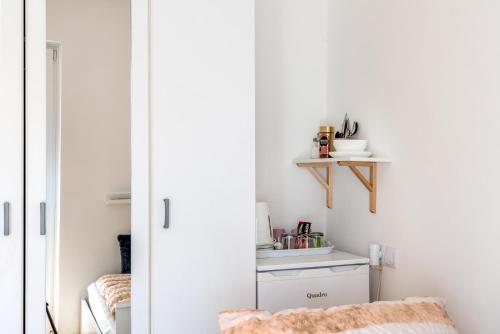 a living room with a closet and a chair at Apartment and Rooms Dalmatiko in Vodice