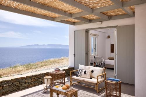 a patio with a view of the ocean at Ianemi Suites by K4 Kythnos in Kithnos