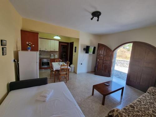 a kitchen and a living room with a table and a couch at Castle in Oitylo in Oítilon