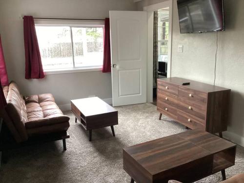 a living room with a couch and a dresser at Train Depot - 3 BR Home with Pool, Sand Volleyball & Pool Table in Montgomery