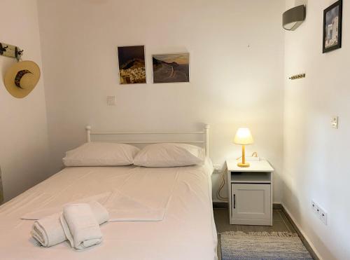 a bedroom with a bed with two towels on it at Aegean breeze apartment in Karpathos