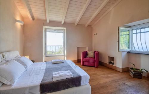 a bedroom with a large bed and a red chair at S Rocco Dimora Tra Ulivi E M in Zoagli