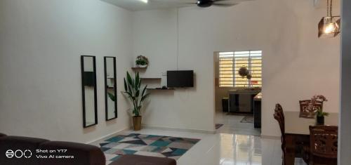 a living room with a couch and a table at NVACASTAY in Marang