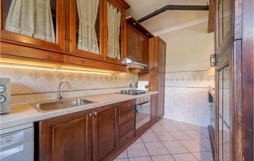 a kitchen with wooden cabinets and a sink at Casa La Selva in Cavizzano