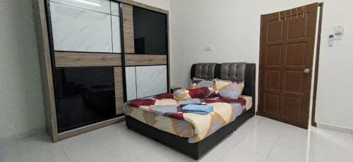 a bedroom with a bed and a large window at NVACASTAY in Marang
