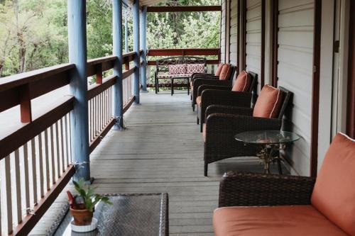 a porch with chairs and tables on a house at Volcano Union Inn and Pub in Volcano