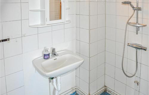 a white bathroom with a sink and a shower at Lovely Home In Lima With Wifi in Lima