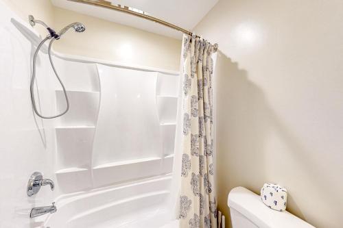 a bathroom with a tub and a shower curtain at Lake Bliss in Mineral