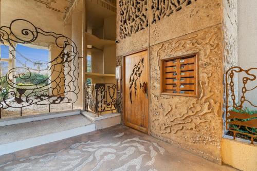 a room with a wooden door and a window at The gaudi house TLV in Tel Aviv