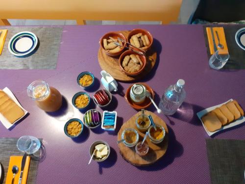 a purple table with food and a basket of food at Oasi di Mastarone - Il vino e le Rose in Momperone