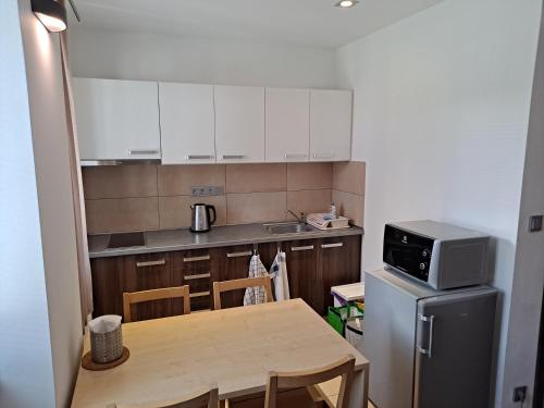 a small kitchen with a table and a microwave at Penzion Na Pohoři in Olešnice