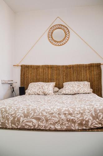 a bedroom with a large bed with a mirror on the wall at HOTELITO RURAL GA7COLORES only adult in Montaña Blanca