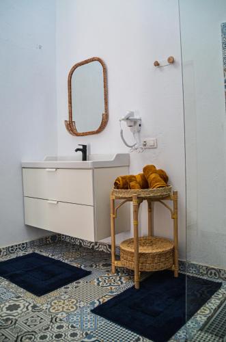 a bathroom with a sink and a mirror at HOTELITO RURAL GA7COLORES only adult in Montaña Blanca