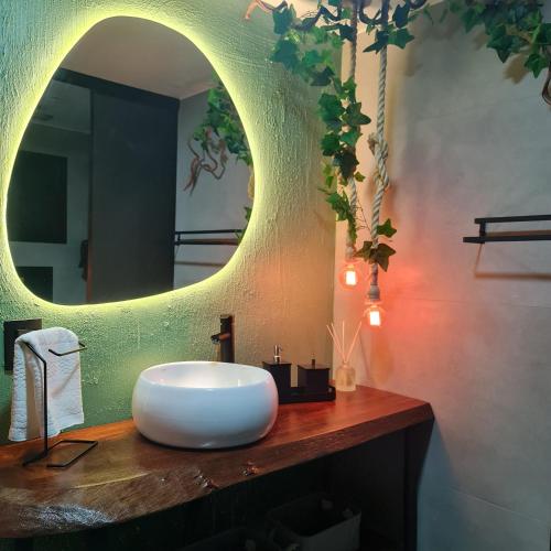 a bathroom with a white sink and a mirror at Casa Container - Haupt Village in Farroupilha
