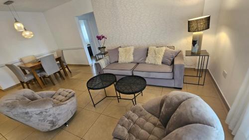 a living room with a couch and chairs and a table at Departamento San Lorenzo in Posadas