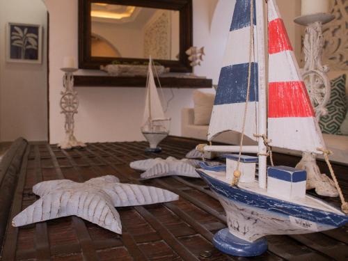 a living room with a toy sailboat on a table at Hotel Casa Agustina in Cartagena de Indias
