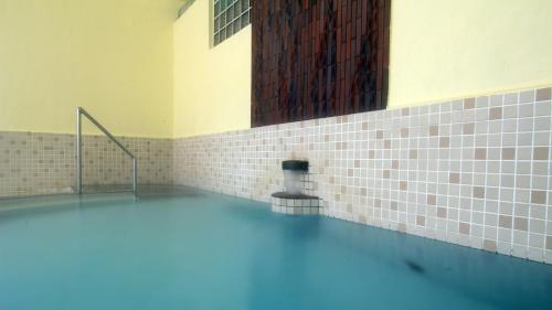 um quarto com piscina de água num edifício em Onsen Hotel Tsutsujiso - Vacation STAY 03263v em Kitami