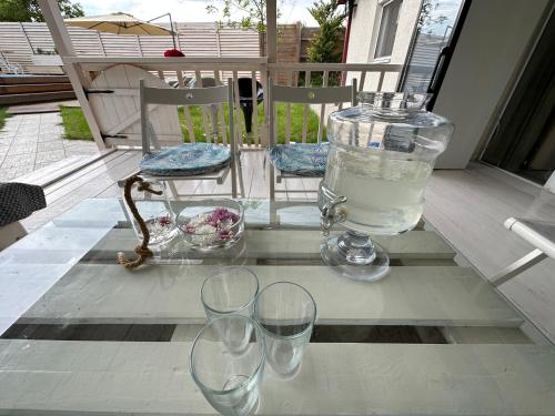 a group of wine glasses sitting on a porch at Pool Garden-Oaza in Skopje