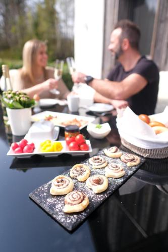 a group of people sitting at a table with food at Wohlfühloase am Trausdorfberg mit Sauna, Whirlpool und Panorama in Sankt Marein bei Graz