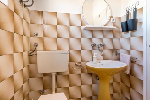 a bathroom with a toilet and a sink at Apartment and Rooms Dalmatiko in Vodice