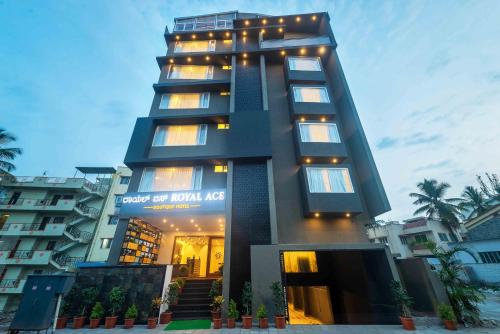 a tall building with lights on top of it at Royal Ace Boutique Hotel - Manyata Techpark in Bengaluru