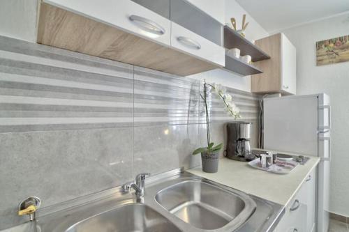 a kitchen with a sink and a counter top at Apartment Fortica in Senj