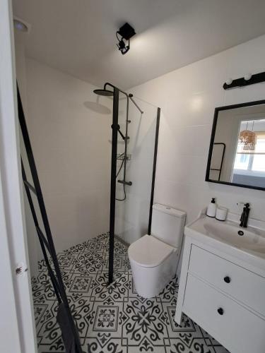 a bathroom with a toilet and a sink and a mirror at Cozy apartment La Mata in La Mata