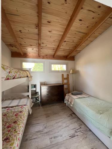a bedroom with two bunk beds and a wooden ceiling at Casa de Campo La Chacra in San Carlos de Bariloche