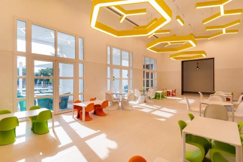 a classroom with tables and chairs and a screen at Al Messila, A Luxury Collection Resort & Spa, Doha in Doha