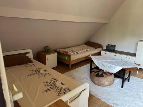 Pokój z 2 łóżkami, stołem i biurkiem w obiekcie Cosy Mountain Villa in Nizepole w mieście Bitola