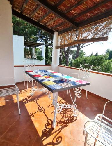 a table and chairs sitting on a porch at Villa Matisse - Damecuta Park in Anacapri