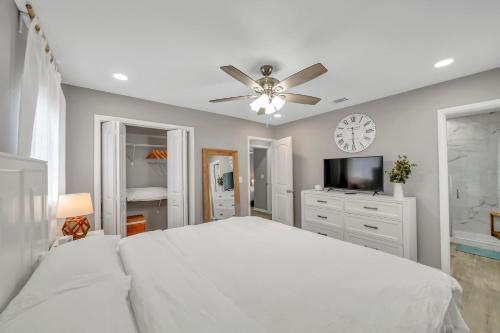 a white bedroom with a bed and a ceiling fan at Magnolia House - Grill Corn hole 3m to Beach in Fort Walton Beach