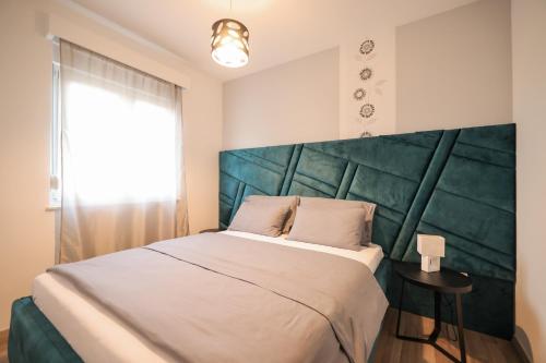 a bedroom with a large bed with a large headboard at Boutique Apartments Ad Astra in Bibinje