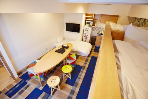 a small room with a table and a bed at Hotel Sanriiott Kitahama - Vacation STAY 33498v in Osaka