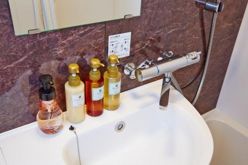 a bathroom sink with four bottles on the counter at Hotel Sanriiott Kitahama - Vacation STAY 33596v in Osaka