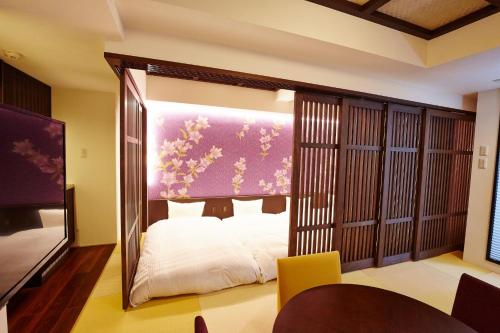 a bedroom with a bed in a room with a mirror at Hotel Sanriiott Kitahama - Vacation STAY 33524v in Osaka