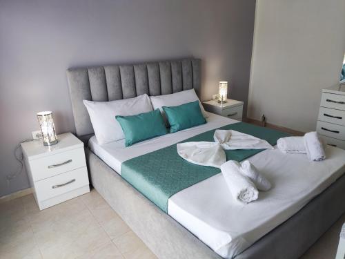a bedroom with a large bed with two night stands at City View Apartments in Lezhë