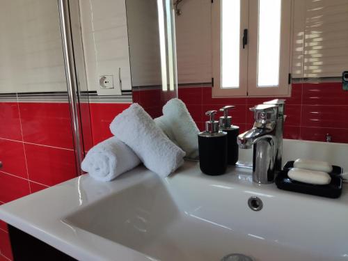 a bathroom sink with towels on top of it at City View Apartments in Lezhë