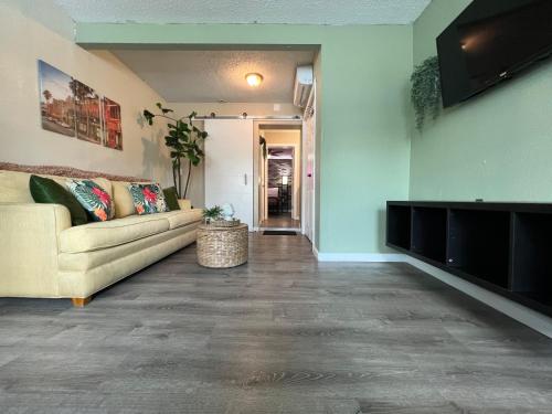 a living room with a couch and a flat screen tv at Apartment near TPA Airport in Tampa