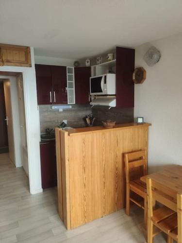 - une cuisine avec un comptoir en bois et une table dans l'établissement Studio La Rosière 1850, à Montvalezan