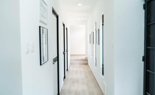 a hallway with white walls and black doors at Casa La Merced in Tarapoto