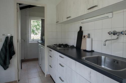 a kitchen with a sink and a counter top at Heuvel 35 in Simpelveld