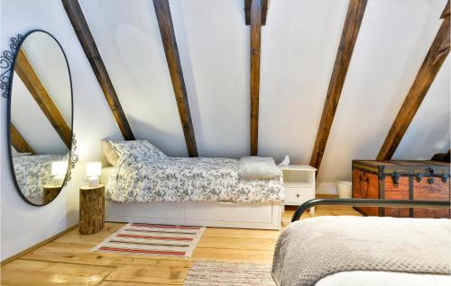 a bedroom with a mirror and a bed in a room at Awesome Home In Popovaca in Popovača