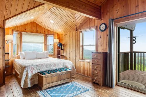 a bedroom with a bed and a large window at Port Angeles Blue Mountain Lodge with Bunkhouse in King Hill