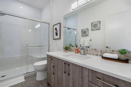 a bathroom with a toilet and a sink and a shower at BEAUTIFUL, ELEGANT AND SPACIOUS 2 & HALF BR HOUSE in Calgary