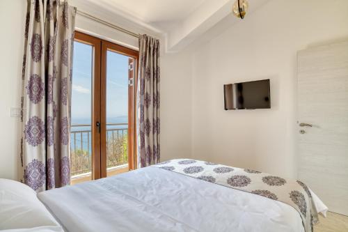 a bedroom with a bed and a window at Seaview Villa Lavanda with pool in Budva